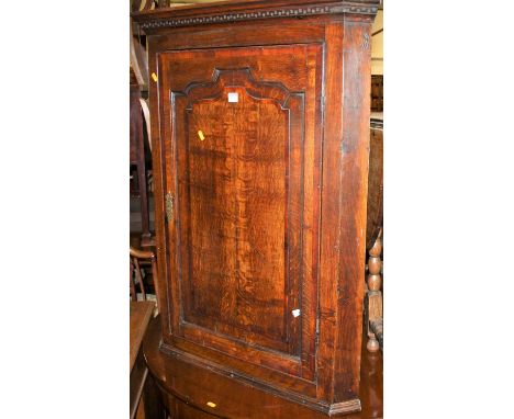 An early 19th century oak and mahogany crossbanded single door hanging corner cupboard; together with an antique joined oak d