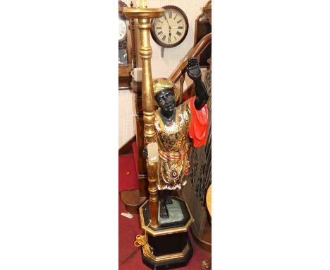 A carved, painted and gilt decorated figural lamp of a standing blackamore on plinth, h.176cm