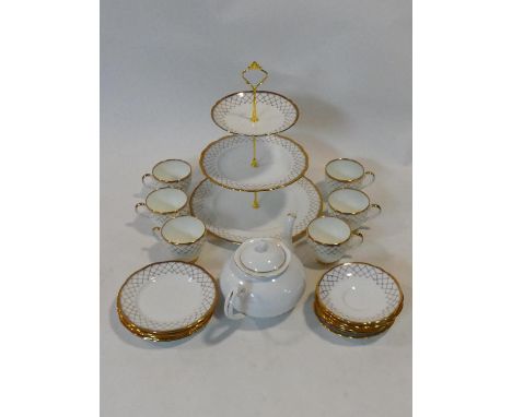 A porcelain six person tea service with 22ct gold highlights by Imperial, includes a three tier cake stand, stamped to bases.