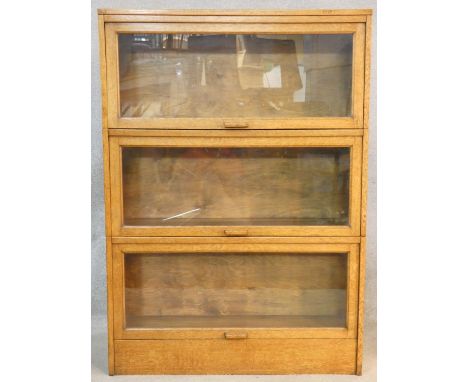 A vintage light oak three section Globe Wernicke style bookcase with patent label for the Meovoto Easyslide. H.123 W.86 D.26c