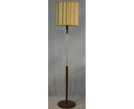 A 1960's vintage brass and teak standard lamp with original textile shade. H.170cm 