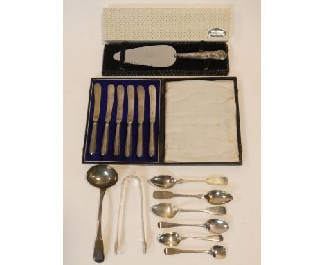 A collection of antique and vintage silver cutlery. Including Georgian sugar tongs and sauce ladle, two grapefruit spoons, te