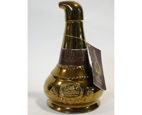 A rare Wade, discontinued pot still shaped decanter from Whyte &amp; Mackay. Aged 12 years old, it is a deluxe blended Scotch