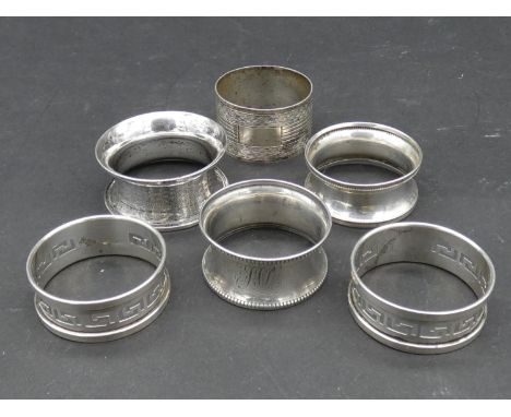 A collection of silver napkin rings. Two with a pierced Greek key design, hallmarked: HG&amp;S for Henry Griffiths and Sons, 