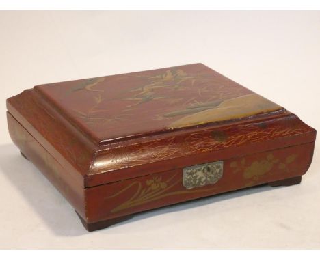 An antique Japanese lacquered fitted gaming box with hand painted gilt decoration depicting a skein of geese containing pierc