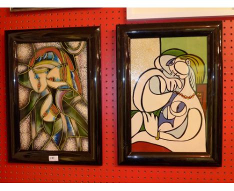 A pair of Picasso style plaques in black frames 