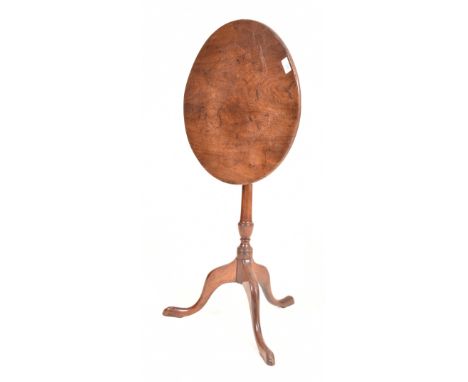 A George III 19th century tilt top wine side table. The table having a circular tilt top. Turned central column all raised on
