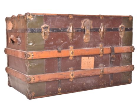 A large early 20th century British steamer trunk travel chest. The trunk with green metal panels throughout and reinforced oa