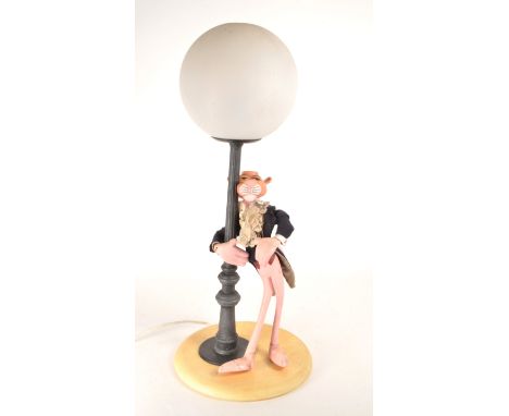 A 20th century vintage Italian Pink Panther novelty lamp light depicting the iconic character leaning on a lamp post in a tux