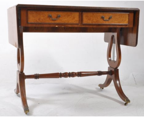 A reproduction 19th century walnut and mahogany drop leaf sofa table - writing desk. Raised on lyre shaped supports with twin