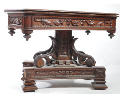 19th century Victorian mahogany swivel top table with ornately carved base. Rectangular form with carved borders and side pan