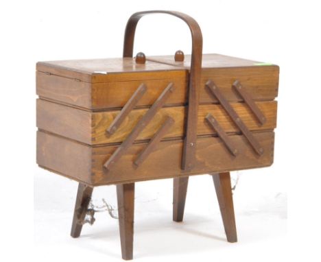 British Modern Design - A mid 20th century stained teak metamorphic / cantilever sewing box / chest. Having a bentwood carry 