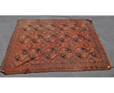 Early 20th century Persian Islamic Afghan Art Deco carpet floor rug. Having repeating shaped medallions in a red ground with 