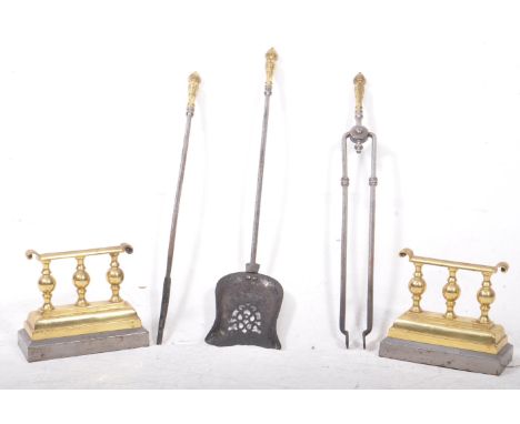 A 19th century set of three polished steel fireside companion set together with a pair of brass and irons. The companion set 