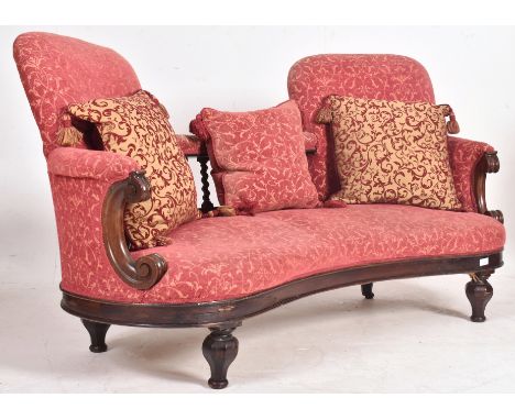 A Victorian 19th century rosewood conversation sofa / chaise longue. The chaise having been recently reupholstered in red vel