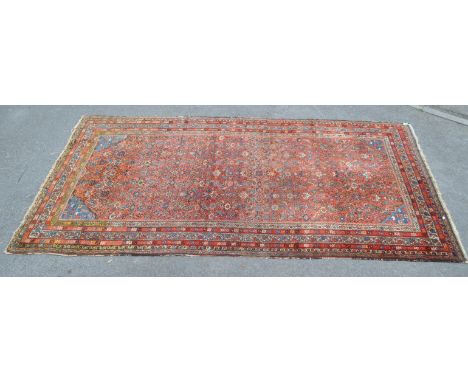 A 20th century Persian Moud carpet floor rug. The rug having red ground, with large densely populated central field. Featurin