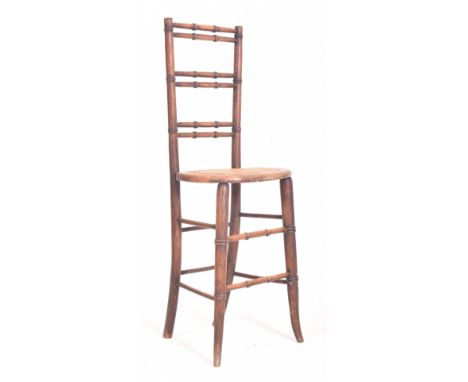 A Victorian 19th century mahogany &amp; rattan children correctional / posture high chair. The chair having a tall fan backre