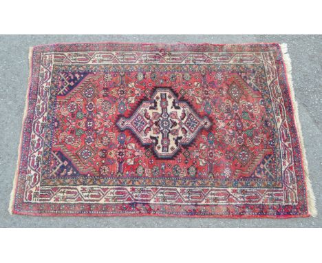 A vintage 20th century Persian Iranian Hamadan carpet rug. The rug having red ground, with large central medallion. The centr