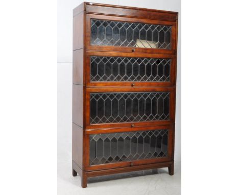 Globe Wernickemanner vintage 20th century four section barrister's lawyers bookcase, with leaded glass panel fronts. Pull kno