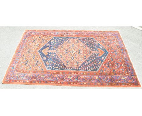 A 20th century Persian Hamadan carpet floor rug. The rug having large central field with geometric oversized medallion popula
