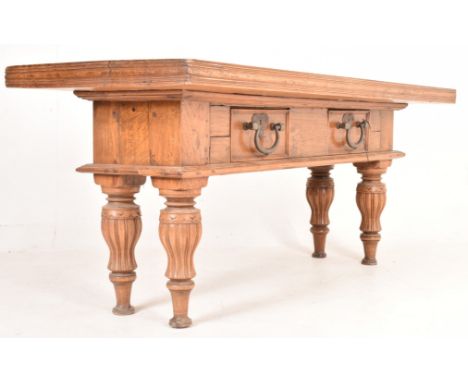 An early 20th century carved hardwood kitchen work table counter. The table having a solid rectangular top over a two drawer 