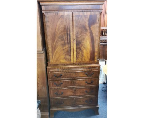 A mahogany four drawer cabinet with slide out shelf and flame mahogany veneer, overall 154 x 72 x 44cm.