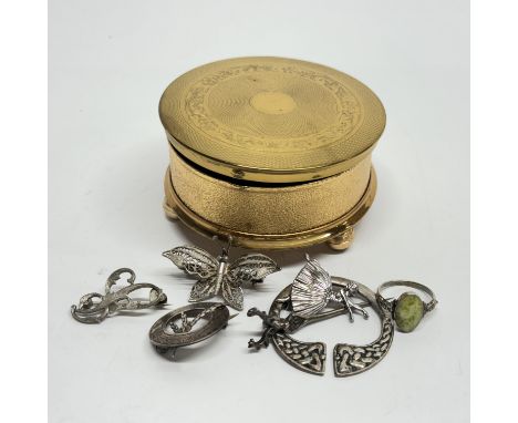 A gilt trinket box containing a group of mixed silver jewellery items.