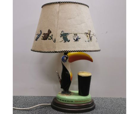 A ceramic Guiness advertising table lamp and shade.