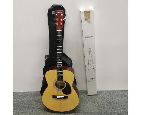 A cased acoustic guitar and stand.