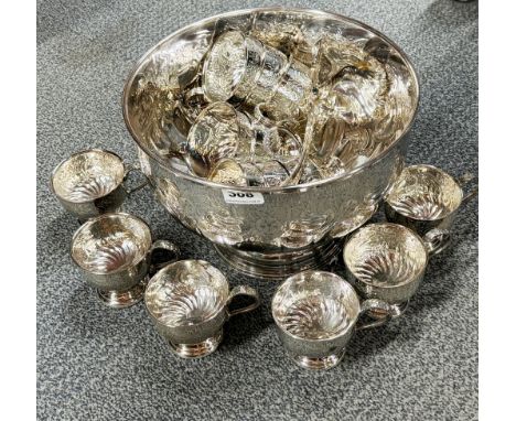 A silver plated punch set with fourteen cups and ladle.
