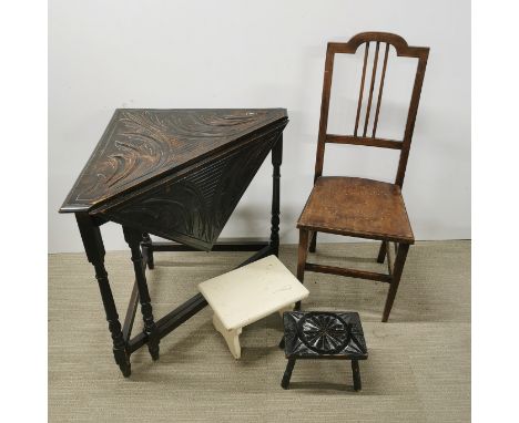 A carved oak drop leaf table with a light wood chair and two stools, table 87 x 84 x 73cm.