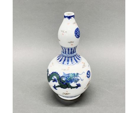 A Chinese hand painted porcelain gourd vase decorated with dragons among clouds.