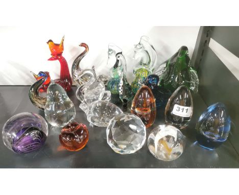 A collection of glass and crystal paperweights.