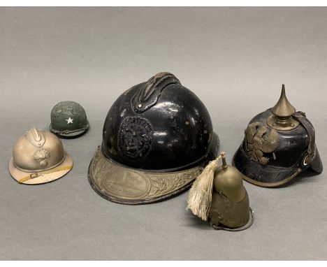 A collection of WWI and other helmet items, largest H. 27cm.