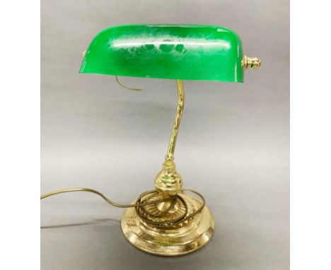 A gilt brass and glass desk lamp.