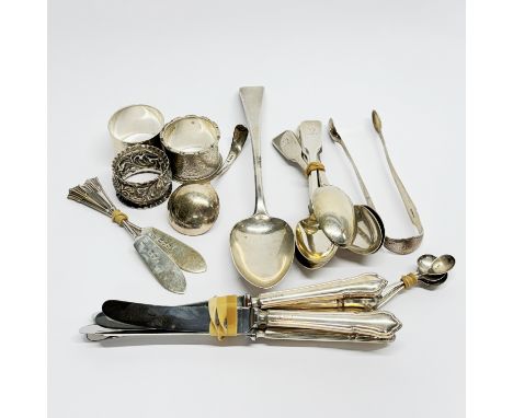 A group of hallmarked silver and silver handled cutlery and napkin rings.