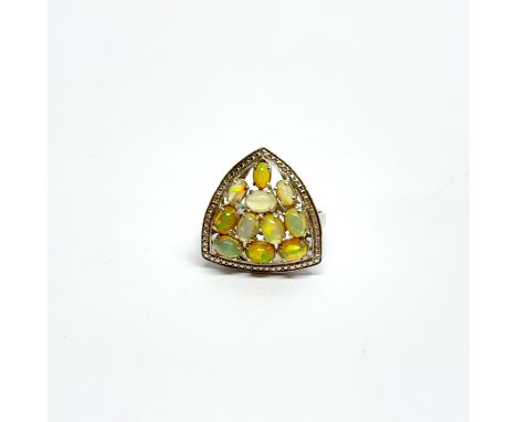 A dramatic sterling silver and opal cluster ring, cluster size 3cm.