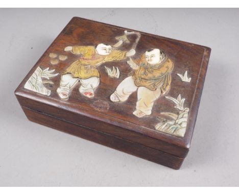A Japanese hardwood four section box with inset mother-of-pearl and wooden figure decoration. 6 1/2" wide (small losses)Condi