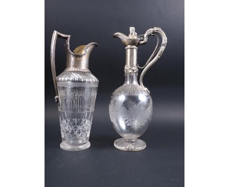 A late 19th century silver mounted claret jug with shell engraved decoration, 11 1/2" high (chip to base), and a similar silv