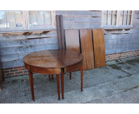 A 19th century mahogany 'D' end dining table with three leaves, on square taper castored supports, 94" long x 48" wide x 29 1