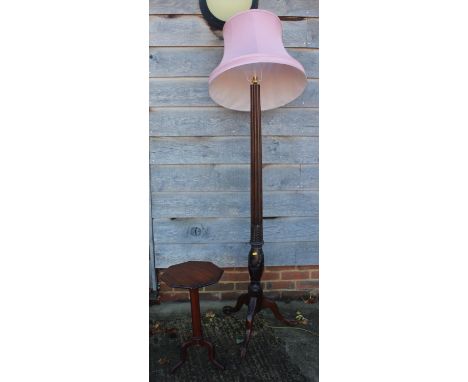 A carved mahogany fluted standard lamp, on tripod splay support, 60" high, and a mahogany octagonal tilt top occasional table