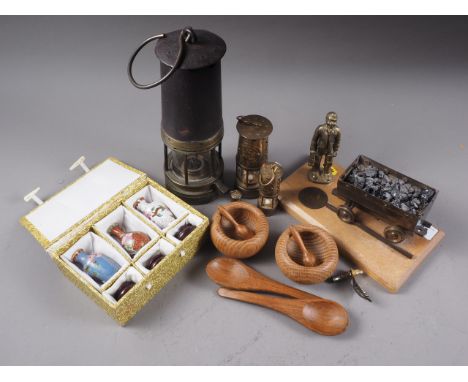 A graduated set of three Davy type lamps, largest 4 3/4" high, a regular sized miners lamp, 9 1/2" high, a cast metal figure 