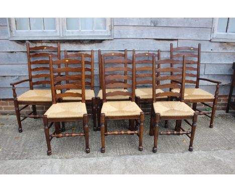 A set of eight oak ladder back dining chairs with rush envelope seats, on turned and stretchered supports (6+2) 
