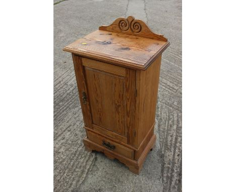 A pine ledge back bedside cupboard enclosed panel door over one drawer, on bracket feet, 18 1/2" wide x 12 3/4" deep x 37" hi