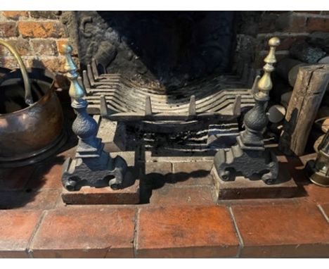 A cast iron fire grate with brass mounted dogs, 24" x 18" 