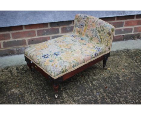 A walnut gout stool, upholstered in a tapestry fabric, on turned and castored supports, and a white painted Lloyd Loom chair 