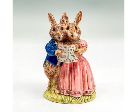Glazed bone china figure of a boy and girl rabbit holding a songbook singing together. He wears a blue jacket and she wears a
