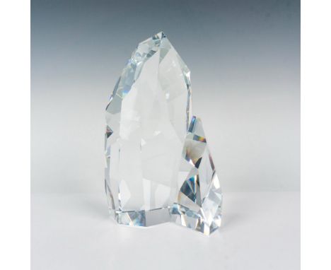 A clear crystal figure in the shape of a iceberg that is cut elegantly to capture the essence of glacial beauty and icy splen