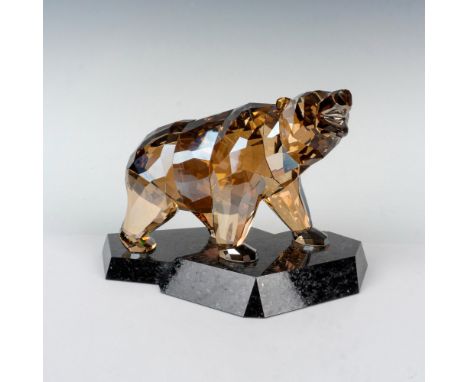 Brilliant topaz hue figure of a masculine bear posed standing on a marble base. A protective animal that considers each move 