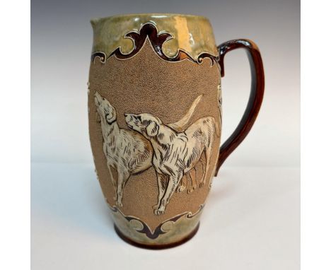 A brown and green glazed handle pitcher featuring pate-sur-pate quails on one side, and incised hounds on the other side. Dou